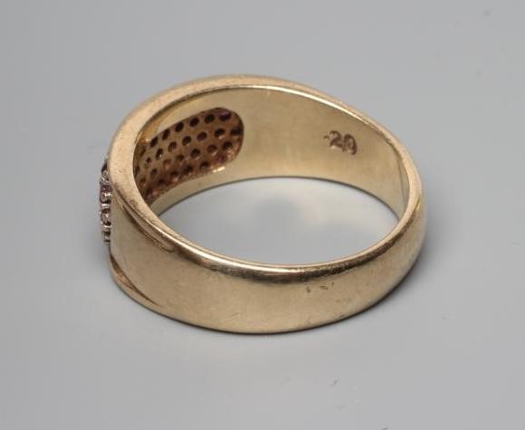 A RUBY AND DIAMOND DRESS RING, the oval panel point set with numerous small diamonds and rubies to a Image