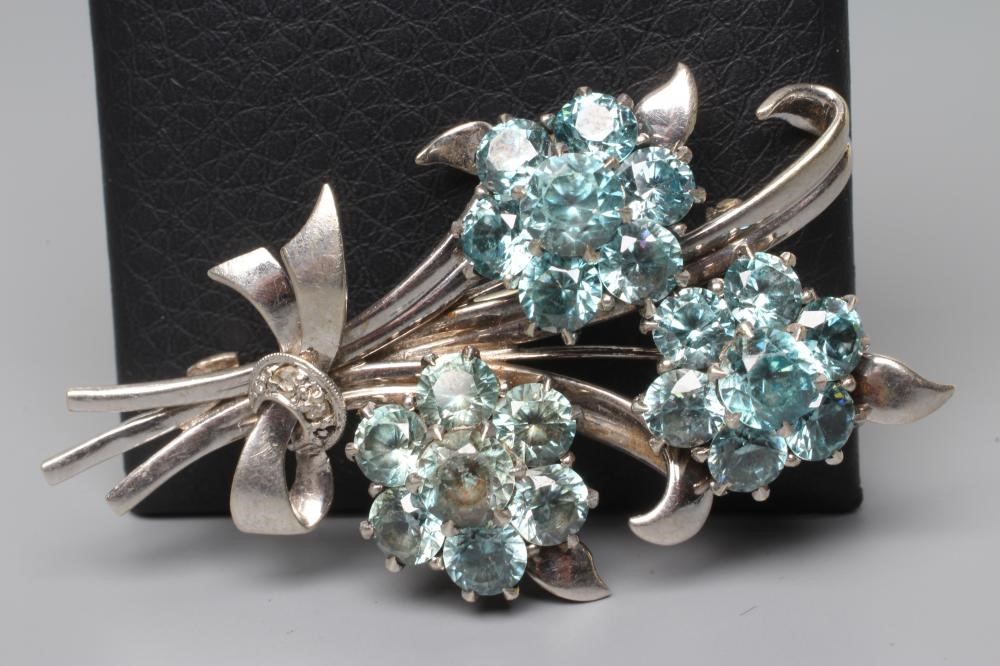 A BLUE TOPAZ TRIPLE FLOWER SPRAY BROOCH Image