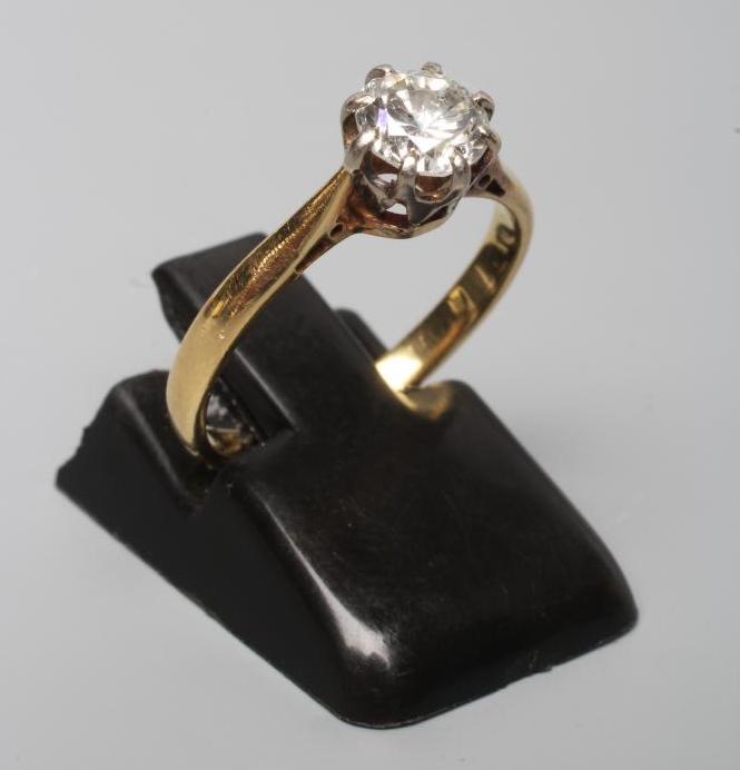 A SOLITAIRE DIAMOND RING, the brilliant cut stone of approximately 0.60cts, claw set to a plain Image