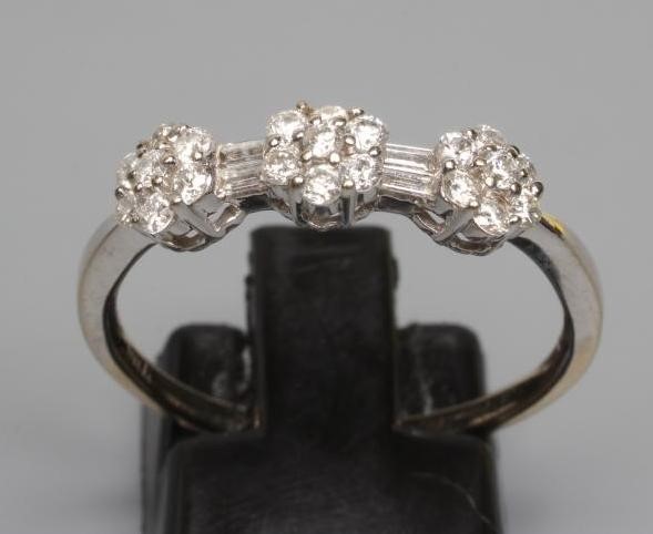 A DIAMOND TRIPLE CLUSTER RING, the seven stone small clusters with two pairs of baguette cut stones Image