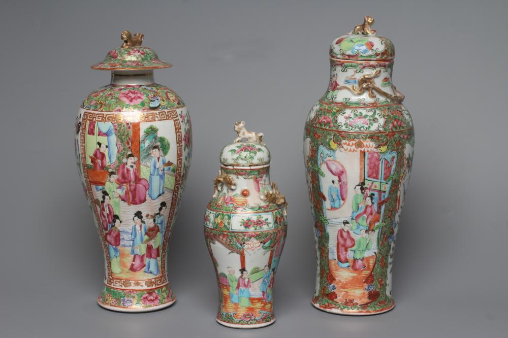 THREE CANTONESE PORCELAIN FAMILLE ROSE VASES AND COVERS of inverted baluster form, all painted with Image