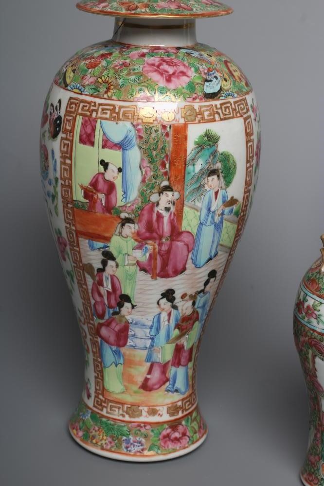 THREE CANTONESE PORCELAIN FAMILLE ROSE VASES AND COVERS of inverted baluster form, all painted with Image