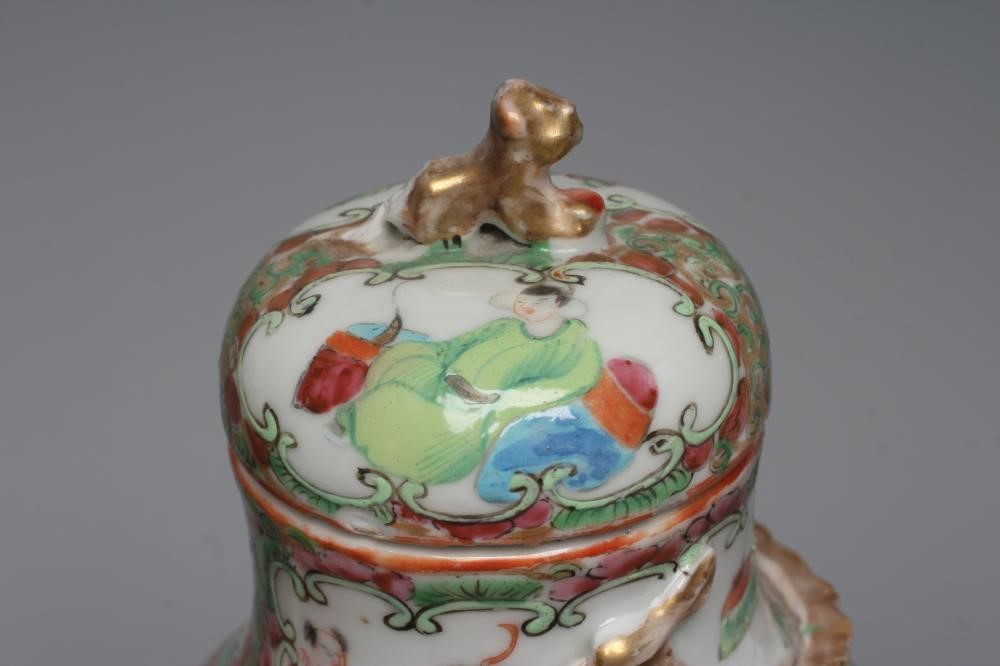 THREE CANTONESE PORCELAIN FAMILLE ROSE VASES AND COVERS of inverted baluster form, all painted with Image