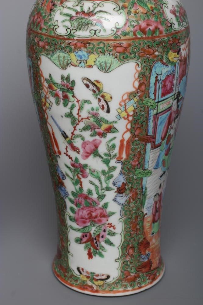 THREE CANTONESE PORCELAIN FAMILLE ROSE VASES AND COVERS of inverted baluster form, all painted with Image
