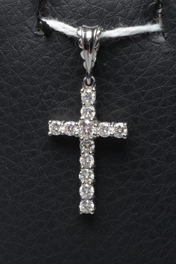 A DIAMOND CROSS PENDANT, the twelve small round brilliants claw set to an 18ct white gold frame with Image