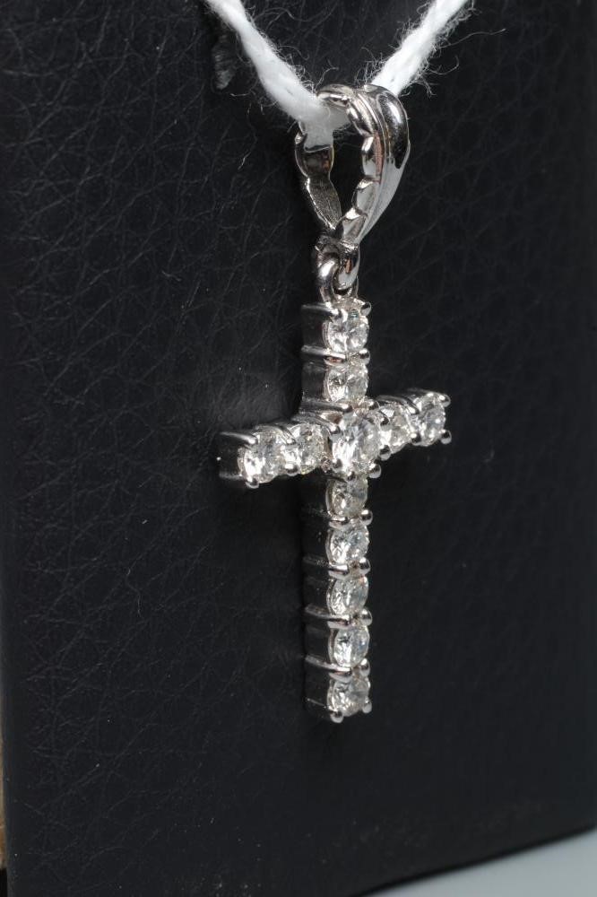 A DIAMOND CROSS PENDANT, the twelve small round brilliants claw set to an 18ct white gold frame with Image