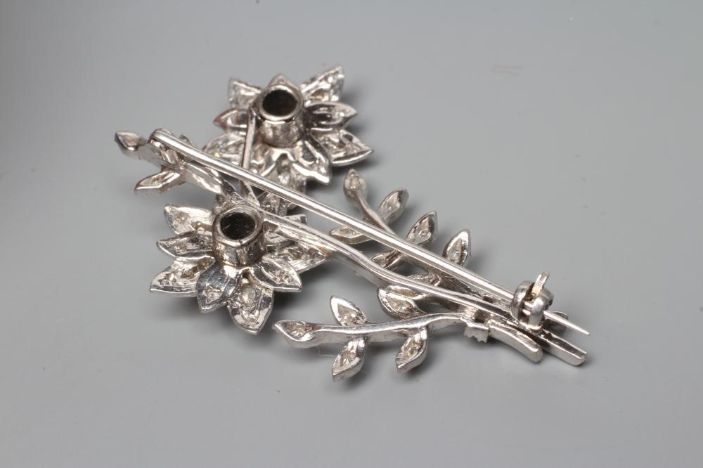 A DIAMOND FLOWER SPRAY BROOCH, the two flowerhead clusters with three leafy branches to an unmarked Image