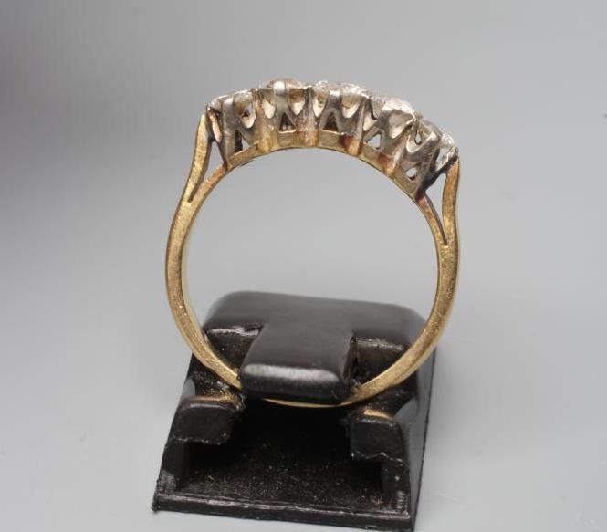 A FIVE STONE DIAMOND RING, the round brilliant cut stones point set to a plain 14ct gold shank, Image