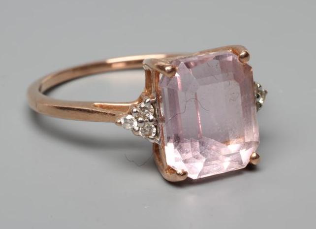 A KUNZITE AND DIAMOND DRESS RING, the oblong cut Kunzite claw set and with three small round Image