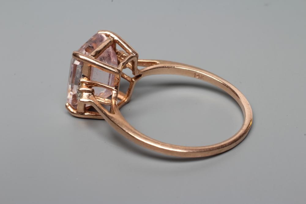 A KUNZITE AND DIAMOND DRESS RING, the oblong cut Kunzite claw set and with three small round Image