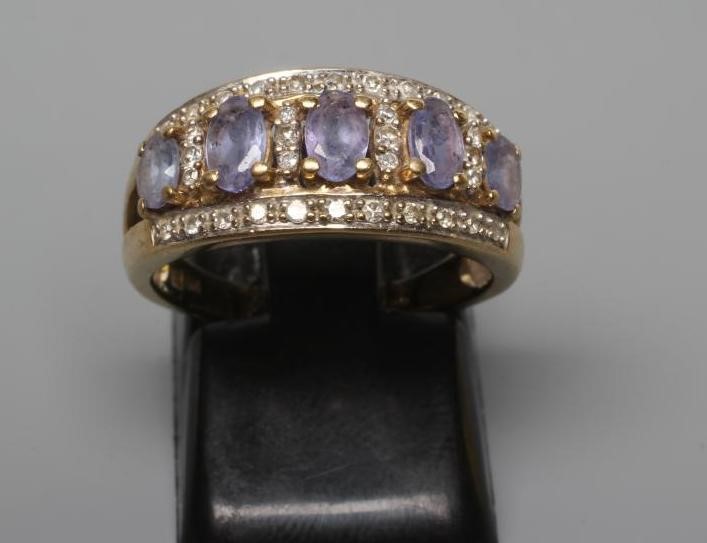 A TANZANITE AND DIAMOND HALF HOOP RING Image