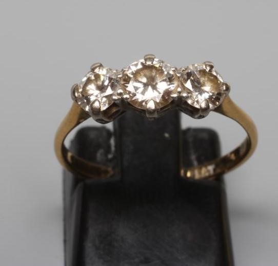 A THREE STONE DIAMOND RING, the old brilliant cut stones of approximately 0.4cts and 0.25cts, claw Image