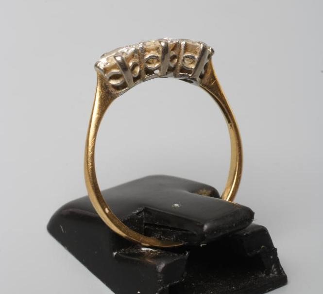 A THREE STONE DIAMOND RING, the old brilliant cut stones of approximately 0.4cts and 0.25cts, claw Image