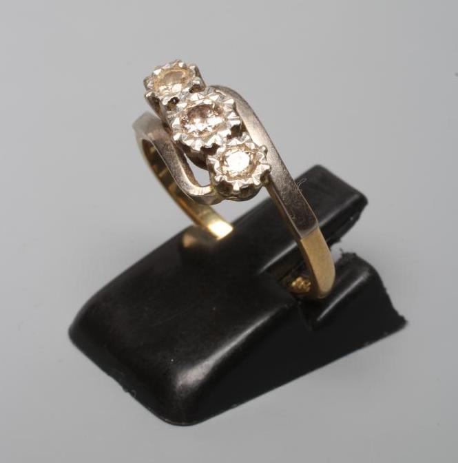 A THREE STONE DIAMOND CROSSOVER RING, the round brilliant cut stones each of approximately 0.12cts, Image