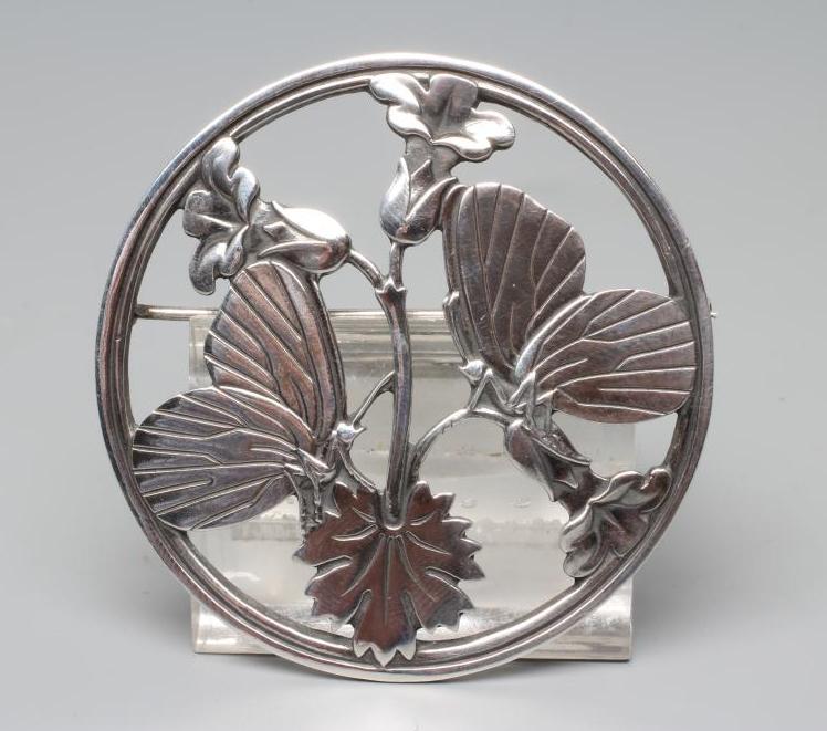 A GEORG JENSEN SILVER CIRCULAR BROOCH designed by Arno Malinowski, cast as a pair of butterflies, Image