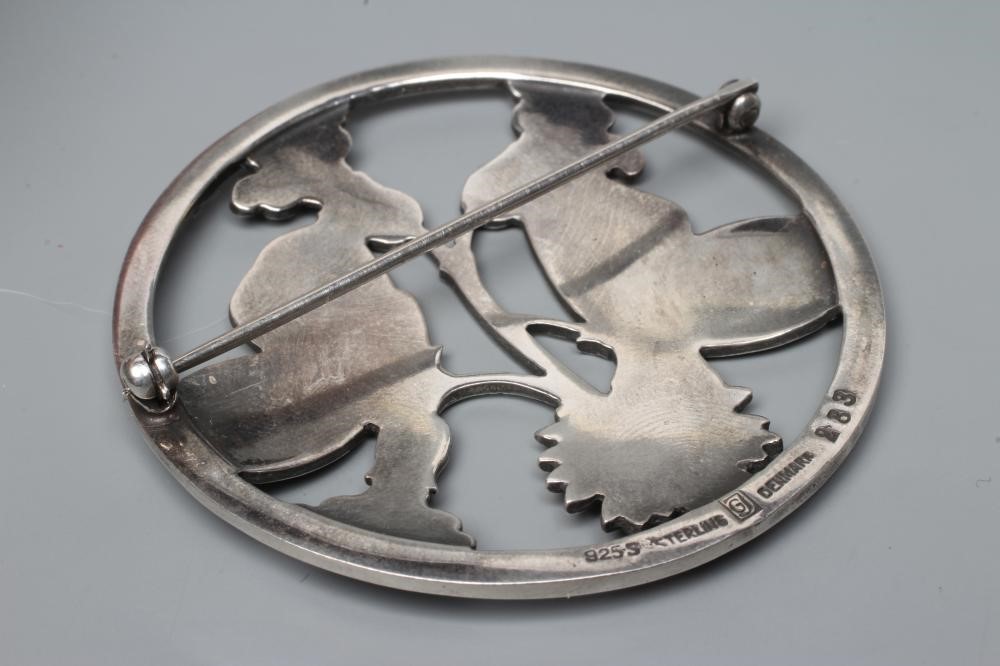 A GEORG JENSEN SILVER CIRCULAR BROOCH designed by Arno Malinowski, cast as a pair of butterflies, Image