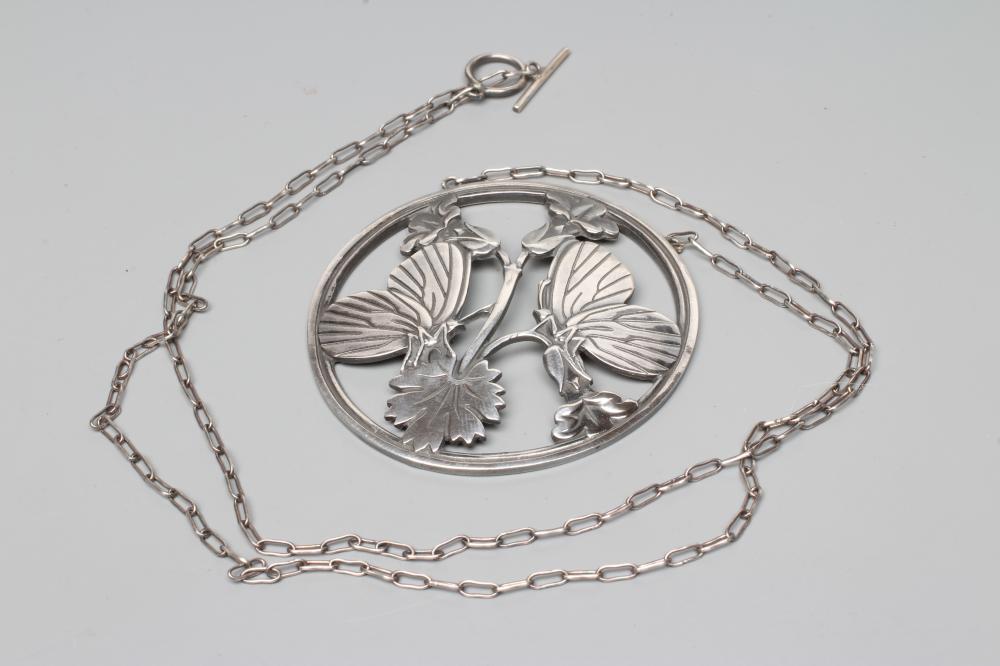 A GEORG JENSEN SILVER CIRCULAR PENDANT to match the previous lot, fixed to a fine chain necklace, Image