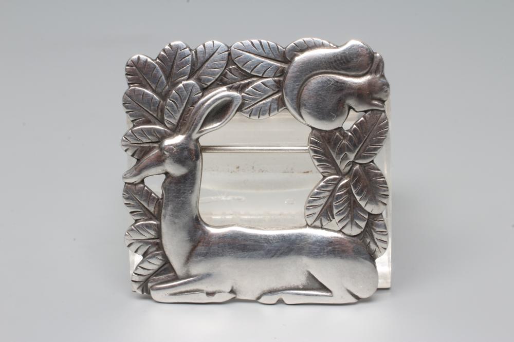 A GEORG JENSEN SILVER SQUARE BROOCH designed by Arno Malinowski, cast as a recumbent deer and Image