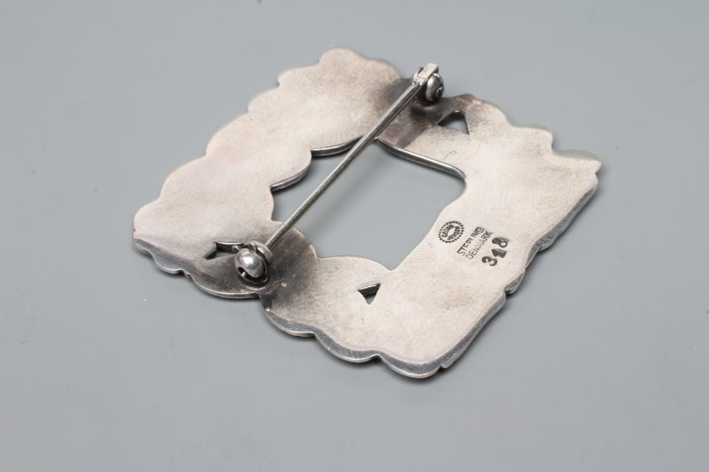 A GEORG JENSEN SILVER SQUARE BROOCH designed by Arno Malinowski, cast as a recumbent deer and Image