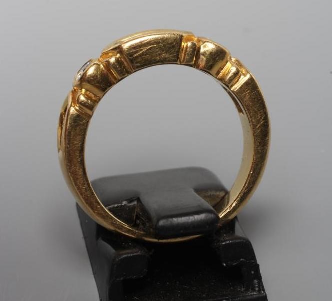 AN EMERALD AND DIAMOND HALF HOOP RING Image