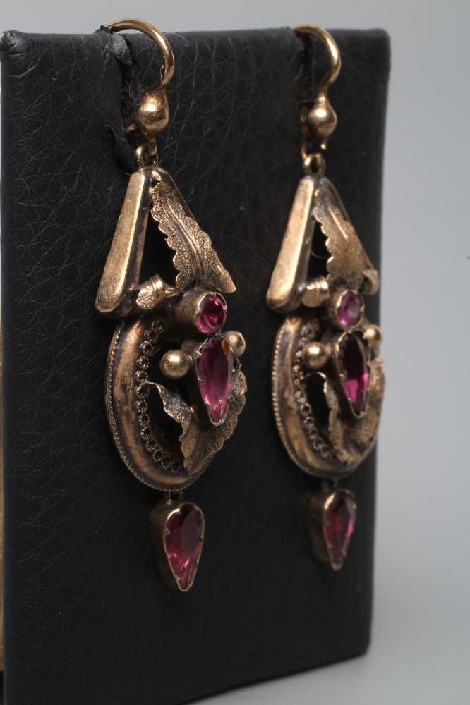 A PAIR OF VICTORIAN EAR BOBS, the open leafy panels centred by mixed cut almandine garnets and hung Image