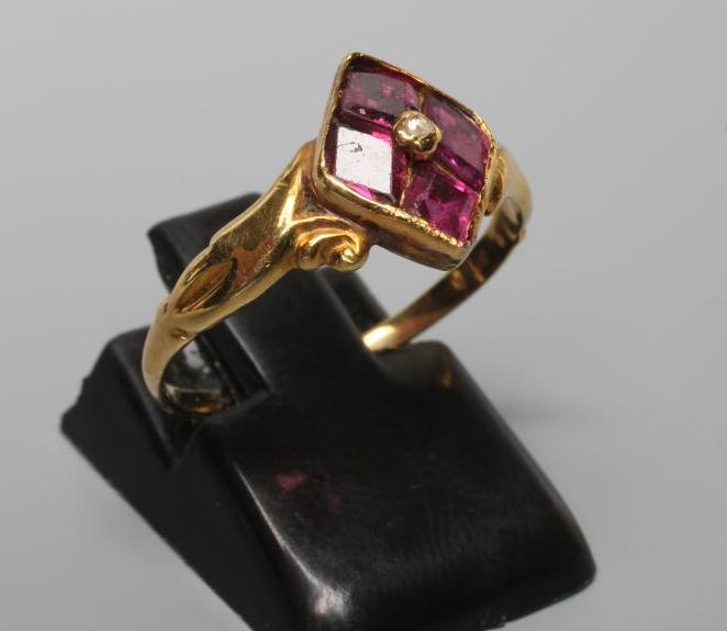 A VICTORIAN ALMANDINE GARNET RING, the lozenge panel set with four stones centred by a bead, to Image