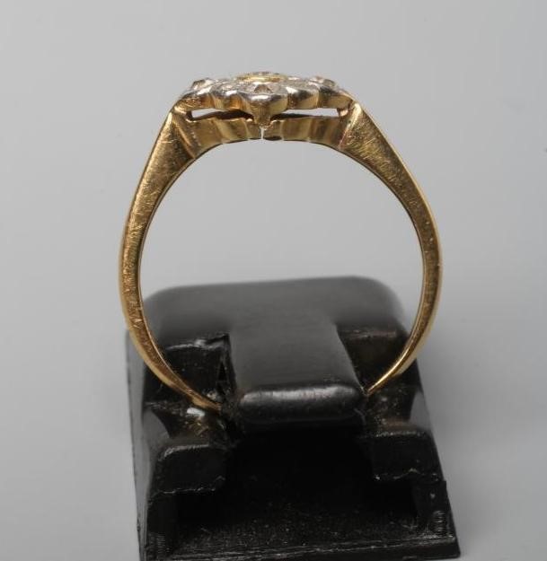 AN ART DECO DIAMOND CLUSTER, the nine small stones collet set in a lozenge panel to a plain shank, Image