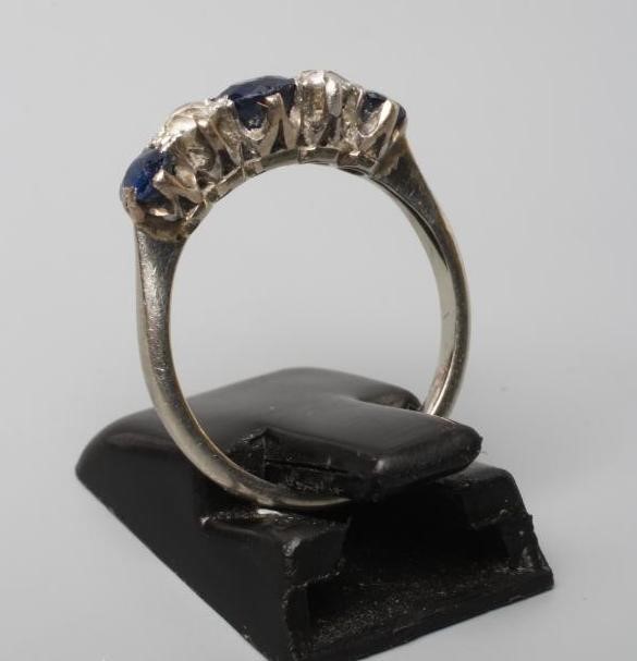 A FIVE STONE SAPPHIRE AND DIAMOND HALF HOOP RING, the three sapphires and two round brilliants claw Image