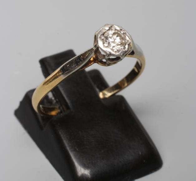 A SOLITAIRE DIAMOND RING, the round brilliant cut stone of approximately 0.20cts illusion set to a Image