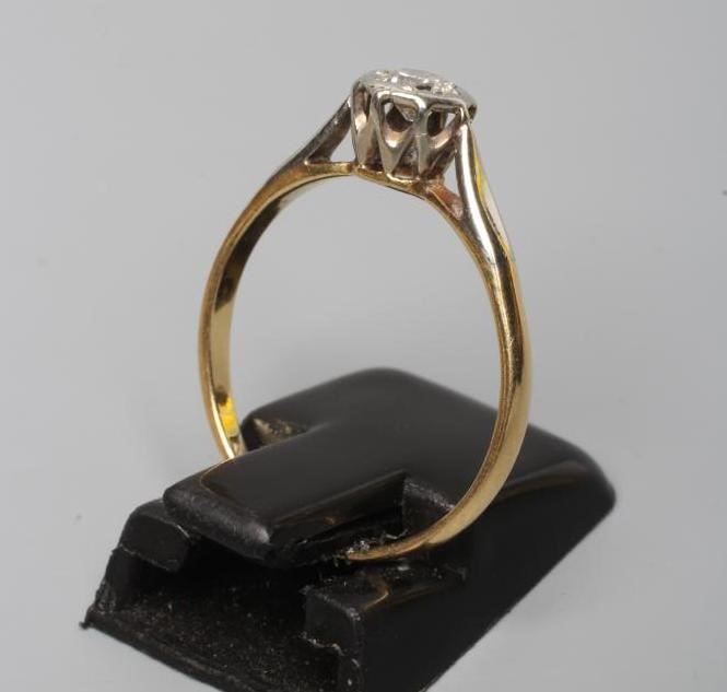 A SOLITAIRE DIAMOND RING, the round brilliant cut stone of approximately 0.20cts illusion set to a Image