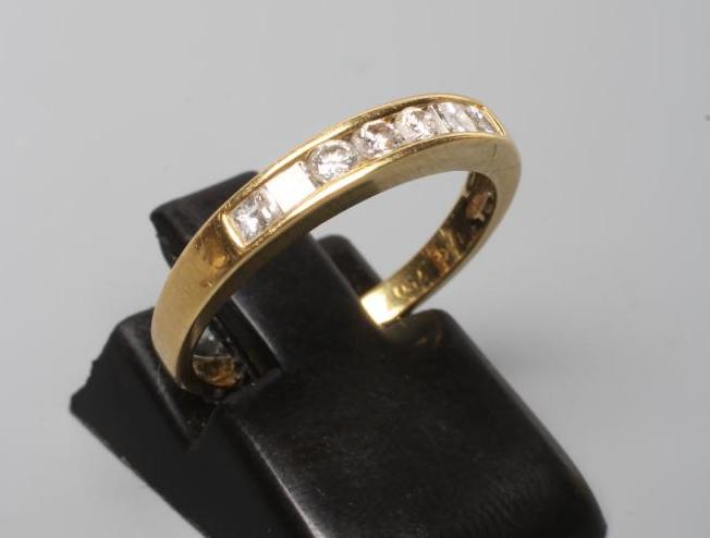 A SEVEN STONE DIAMOND HALF HOOP RING, the three round brilliants flanked by two pairs of square cut Image