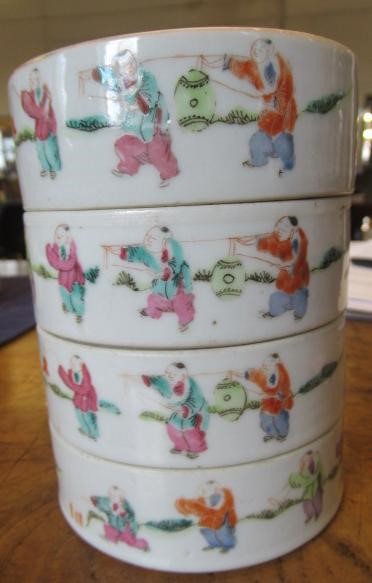 A CHINESE PORCELAIN CYLINDRICAL THREE TIER STACKING BOX AND COVER painted in pastel enamels with Image