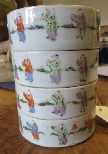 A CHINESE PORCELAIN CYLINDRICAL THREE TIER STACKING BOX AND COVER painted in pastel enamels with Image