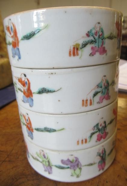 A CHINESE PORCELAIN CYLINDRICAL THREE TIER STACKING BOX AND COVER painted in pastel enamels with Image