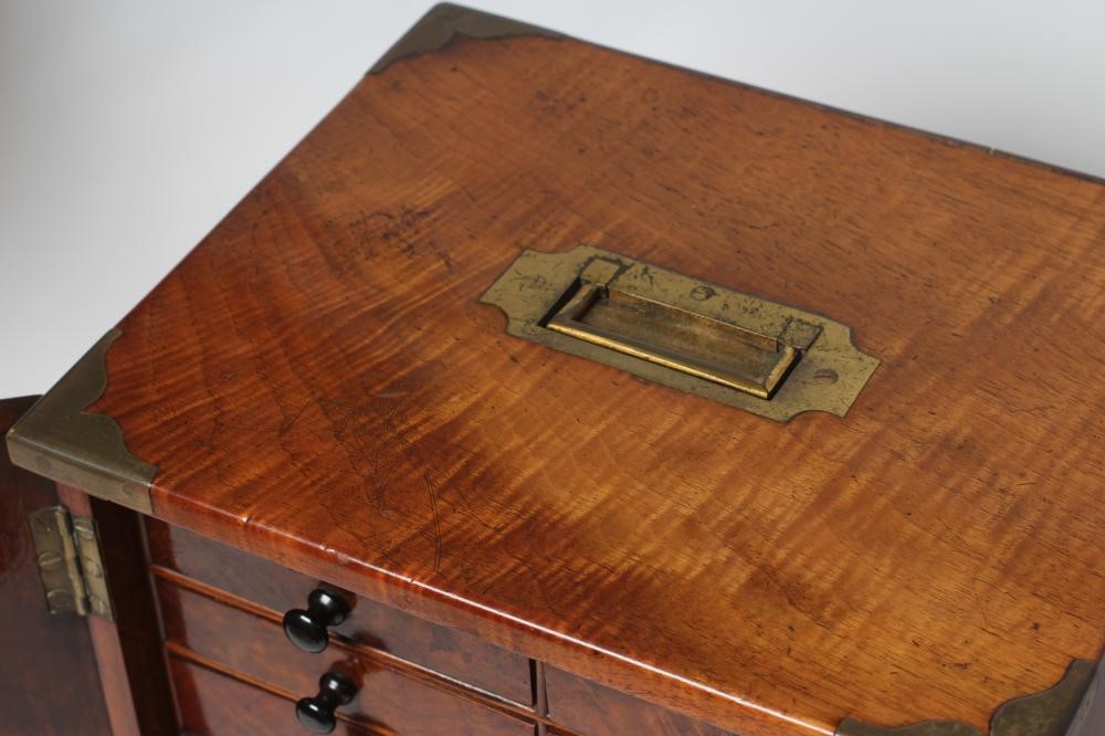 A VICTORIAN WALNUT SPECIMEN TABLE CABINET of oblong form with brass campaign carrying handle and Image