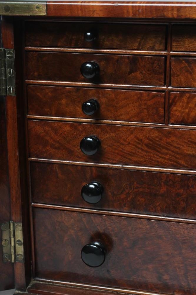 A VICTORIAN WALNUT SPECIMEN TABLE CABINET of oblong form with brass campaign carrying handle and Image