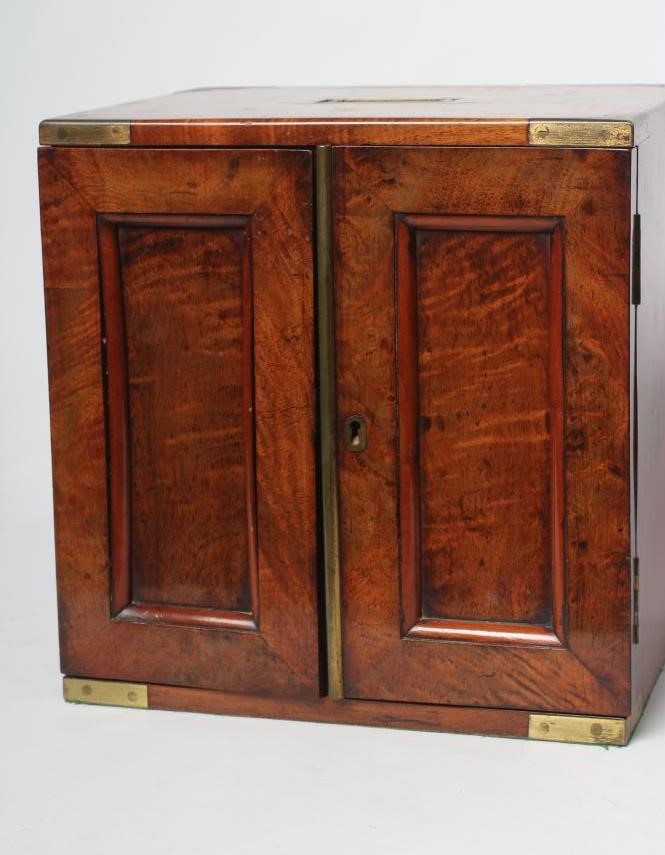 A VICTORIAN WALNUT SPECIMEN TABLE CABINET of oblong form with brass campaign carrying handle and Image