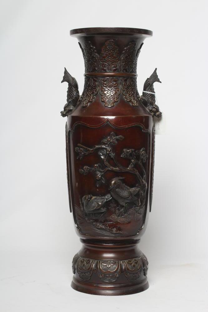 A JAPANESE BRONZE VASE of cylindrical form with two dolphin handles, cast in relief with wading Image