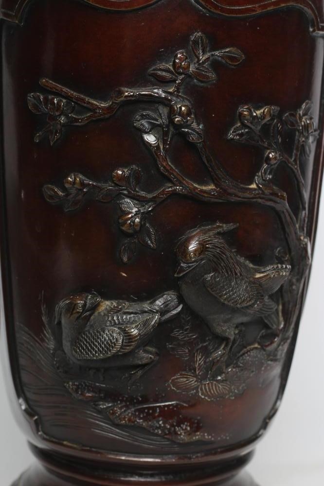 A JAPANESE BRONZE VASE of cylindrical form with two dolphin handles, cast in relief with wading Image
