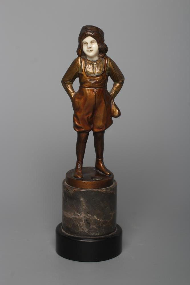 B. GRUNDMANN - An Art Deco bronze figure cast as a young boy with carved ivory face wearing a cap on Image