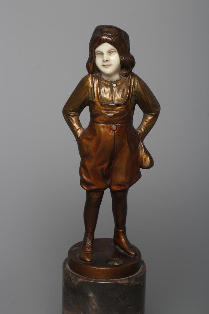 B. GRUNDMANN - An Art Deco bronze figure cast as a young boy with carved ivory face wearing a cap on Image