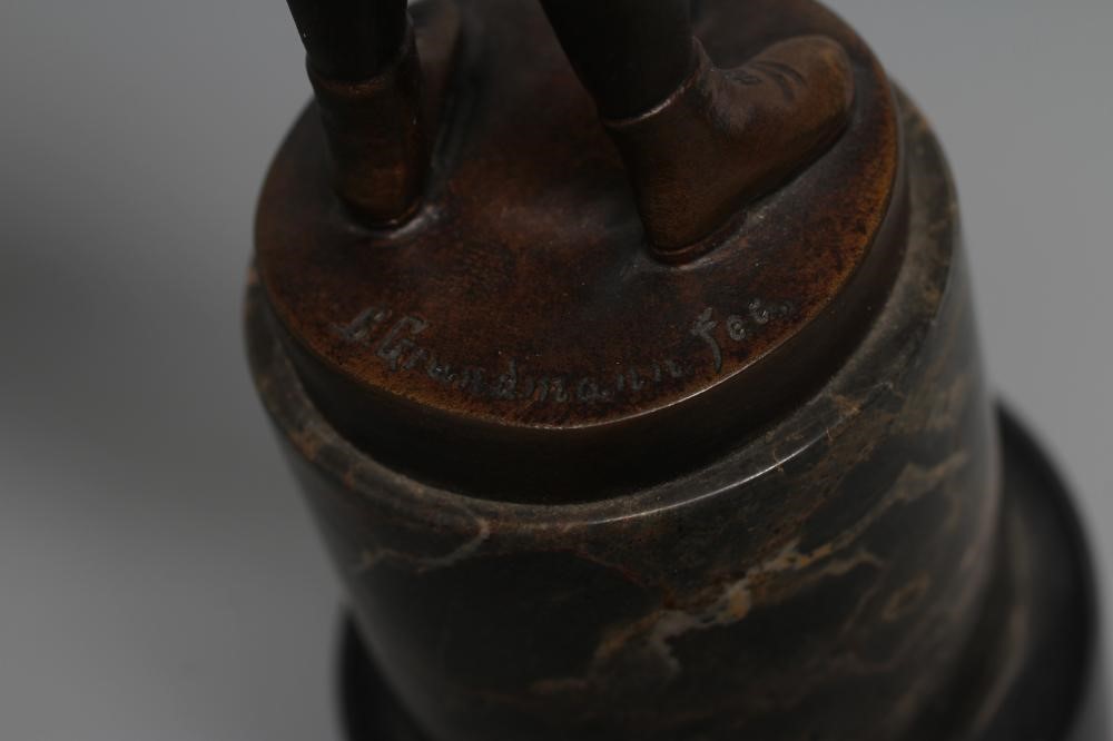 B. GRUNDMANN - An Art Deco bronze figure cast as a young boy with carved ivory face wearing a cap on Image