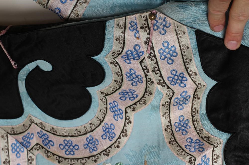 A CHINESE SILK ROBE embroidered in coloured silks with flowers Image