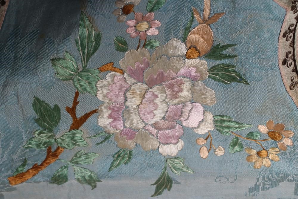 A CHINESE SILK ROBE embroidered in coloured silks with flowers Image