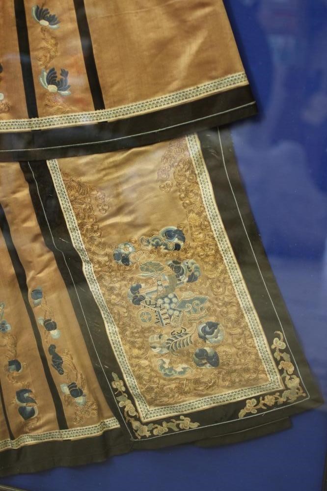 A CHINESE PLEATED SKIRT with black silk satin gores, and blue embroidered foliate panels, with Image