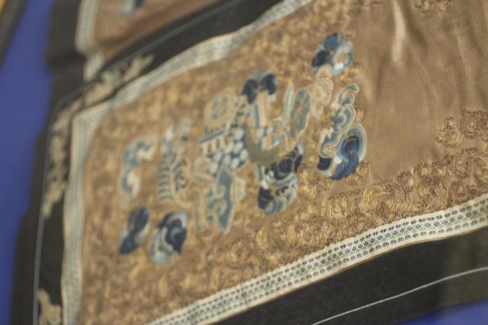 A CHINESE PLEATED SKIRT with black silk satin gores, and blue embroidered foliate panels, with Image