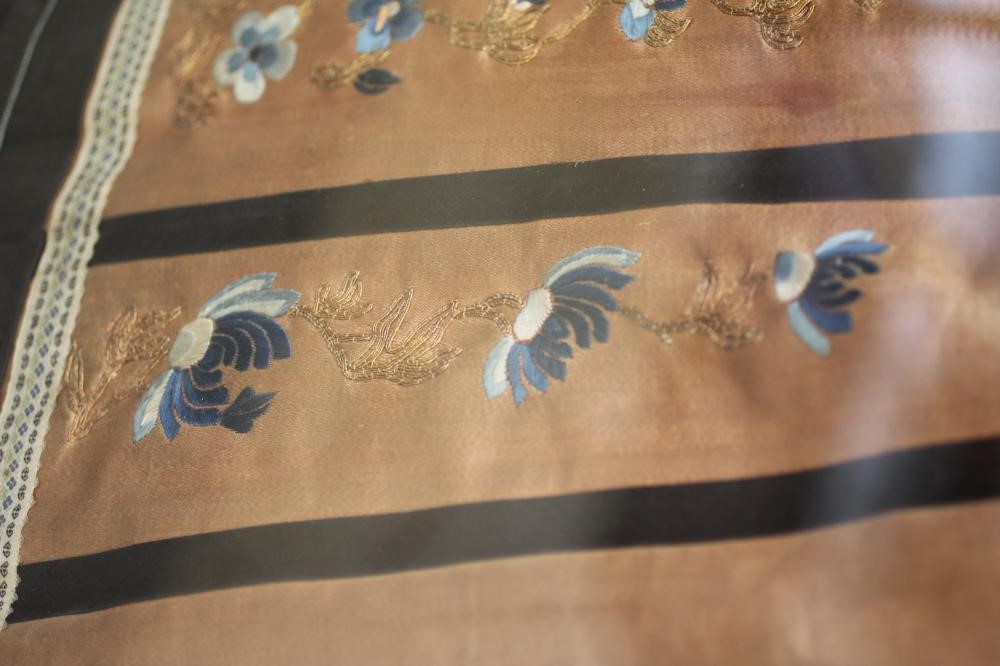 A CHINESE PLEATED SKIRT with black silk satin gores, and blue embroidered foliate panels, with Image