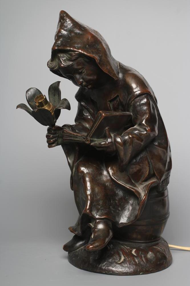 A BRONZED METAL FIGURAL TABLE LAMP, 20th century, modelled as a hooded child seated on a barrel, Image
