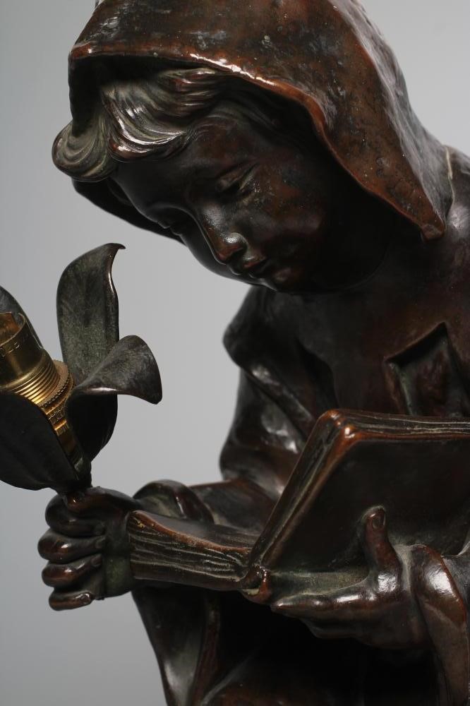 A BRONZED METAL FIGURAL TABLE LAMP, 20th century, modelled as a hooded child seated on a barrel, Image