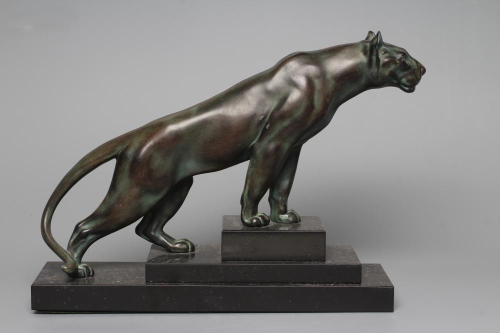 AN ART DECO BRONZED SPELTER LIONESS modelled standing with alert expression, green patination, Image